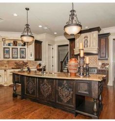 a large kitchen with an island in the middle and lots of cabinets on both sides