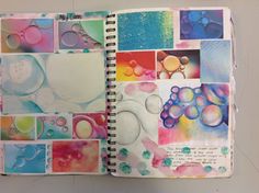 an open notebook with watercolors on it