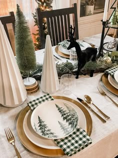 a table set for christmas with plates and napkins