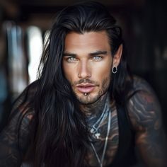 a man with long black hair and piercings