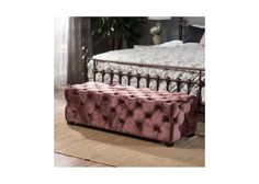 a bed with a pink tufted upholstered bench