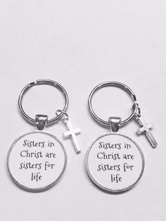 two keychains with the words sisters in christ are sisters for life on them