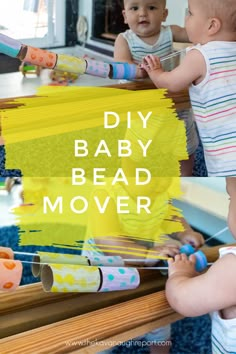 two babies playing with toys in front of a mirror that says diy baby bead mover