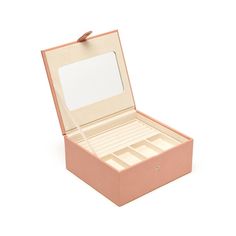 an open pink box with two drawers and a mirror on the top, sitting in front of a white background