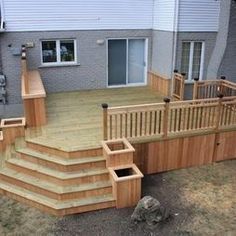 a wooden deck with steps and railings in front of a house on a mobile device