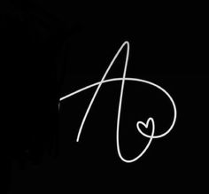 the letter a is written in white chalk on a black background with a small heart