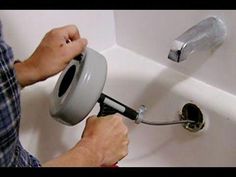 a person using a paint roller to fix a sink faucet