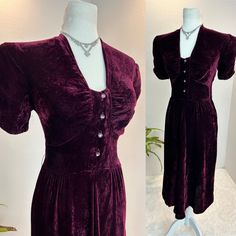 "1940s dress / 40s dress / 1940s velvet dress This is a stunning early 1940s dress in a lovely shade of cranberry. She is made from a lush velvet and has rhinestone encrusted buttons up the front. She has puffed sleeves with gorgeous ruche sleeves. She has a side metal zipper and so much 1940s style. Measurements provided are flat and have been doubled. Bust 36\" Waist 26\" Hips free Length 44\" Shoulders 14.5\" ❤️ Condition: Excellent vintage condition. Flaw: none found. This item has been clea Vintage Fitted Velvet Dress, Velvet Vintage Dress For Vintage Events, Fitted Vintage Velvet Dress, Vintage Velvet Cocktail Dress, Vintage Burgundy Dress For Evening, Vintage Burgundy Evening Dress, Burgundy Vintage Evening Dress, 1940’s Dresses, Lame Dress