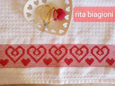 the table is decorated with red and white hearts, gold scissors and a heart brooch