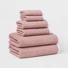 six pink towels stacked on top of each other