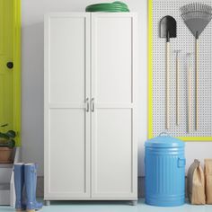 a white cabinet sitting next to a blue trash can