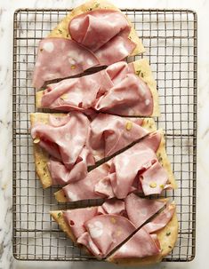 ham and cheese spread on top of crackers on a cooling rack