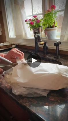 a person cutting paper on top of a counter