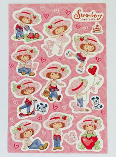 a pink sticker sheet with children's pictures and hearts on the back of it