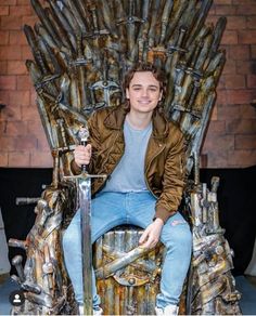 a young man sitting on the iron throne