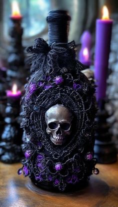 a bottle with a skull in it sitting on a table next to candles and other decorations