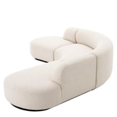 a large white couch sitting on top of a white floor next to a black base