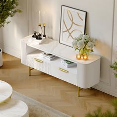 a living room with white furniture and flowers on the table