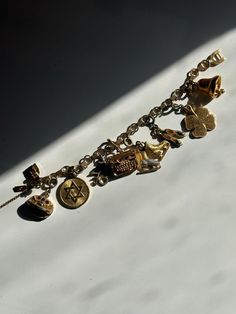 a beautiful vintage gold-tone, charm bracelet. features some special gold tone charms. in good vintage condition.with some west on a few charms. please see all pictures and use zoom feature.  charms included  * phone with rhinestones  * star of david medallion  * typewriter with rhinestones  *ice skates  * ballet shoes  * four leaf clover  * bell Gold Charm Bracelet, Star Of David, Four Leaf Clover, Typewriter, Ice Skating, Gold Charm, Ballet Shoes, Vintage Gold, Charms