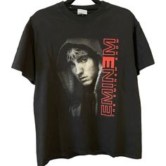 a black t - shirt with an image of emi on the front and red lettering