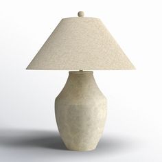 a white vase with a lamp on top of it in front of a white background