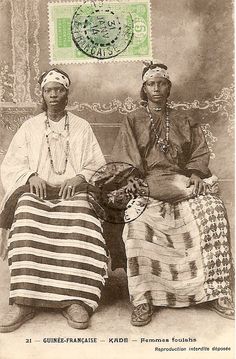 two women sitting next to each other in front of a stamp