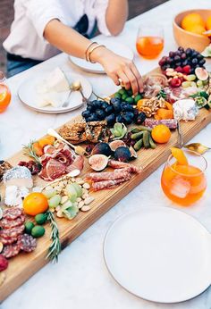 a table topped with plates and bowls filled with different types of food on top of it