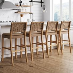 four wooden bar stools in a kitchen