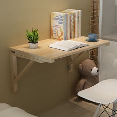 a desk with books and a teddy bear on it