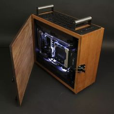 a computer case with the door open on a black background, it appears to be made out of wood