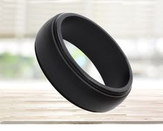 a black ring sitting on top of a wooden table