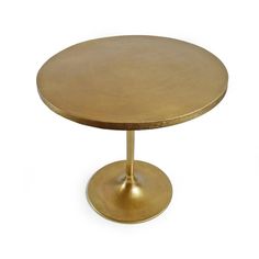 a round brass table with a metal base on an isolated white background for use as a centerpiece