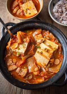 tofu and vegetables in a stew with rice on the side, ready to be eaten