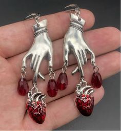 Creep out all your friends with these bleeding heart Goth earrings. Heart Organ, Blood Drop, Hand Heart, Goth Earrings, Red Blood, Heart Hands, Edgy Fashion, Heart Earrings, Elegant Style