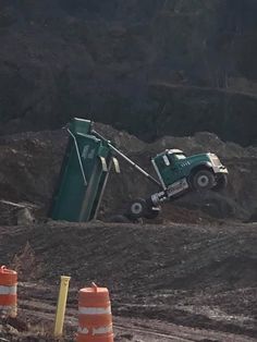 there is a dump truck in the dirt