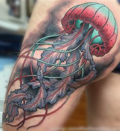 an octopus tattoo on the arm with colorful lines coming out of it's tentacles