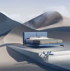 a bed sitting in the middle of a desert