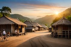 people riding bikes down a dirt road near huts