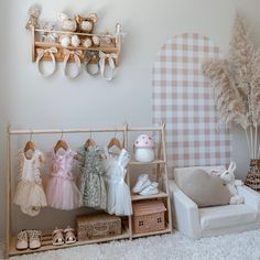 a baby's room with clothes and toys on display