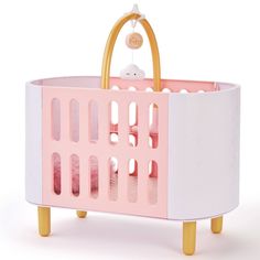 a pink and white crib with a stuffed animal in the top part, on a white background