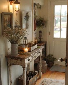 a room with a table, potted plants and candles