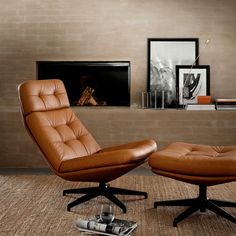 an office chair and ottoman in front of a fireplace with a magazine on the floor