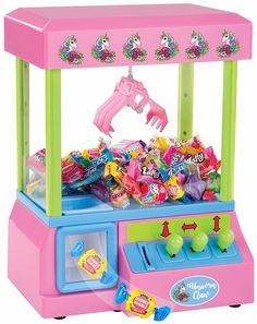 a pink and green toy machine with lots of candy