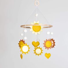 a mobile with sun and hearts hanging from it