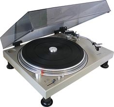 an old record player sitting on top of a turntable with its cover open and the lid up