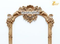 an ornate wooden frame with carved flowers and leaves on the top, against a white background