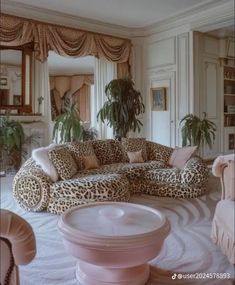 a living room with leopard print furniture and potted plants