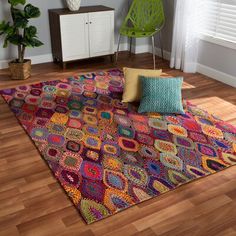 a multicolored rug on the floor in a living room