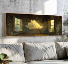 a painting hanging on the wall above a couch in a room with a white sofa