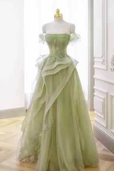 Discover the epitome of sophistication with "Nellie," an elegant green tulle lace long prom dress that exudes grace. This enchanting A-line silhouette boasts an alluring off-the-shoulder neckline, sleek sleeveless design, and a lace-up back for a flawless fit. Adorned with a unique horsehair skirt and exquisitely appliqued illusion corset, this dress is perfect for any formal event or enchanting evening. Details: Silhouette: A-Line Style Fabric: Lace Fabric Color: Green, Black, Pink & White Color Length: Floor Length Neckline: Off the Shoulder Neckline Sleeves: Sleeveless Back: Lace-Up Back Embellishment: Horse Hair Skirt, Appliqued & Illusion Corset Lace Long Prom Dress, Prom Dresses Off The Shoulder, Green Formal Dresses, Fest Outfits, Dress With Corset, Strapless Prom Dress, Green Tulle, Floor Length Prom Dresses, Lace Prom Dress